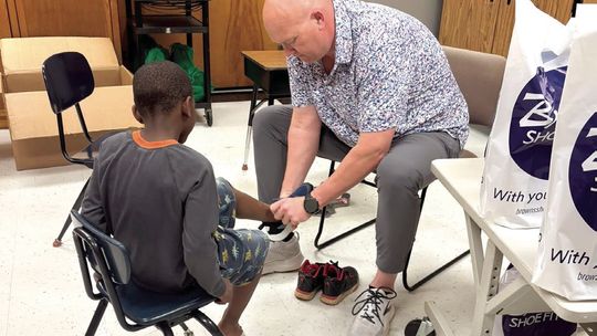 Brown's Shoe Fit Macomb, Noon Rotary Donate 55 'Kicks'