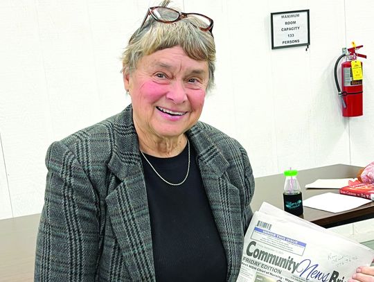 Cheryl Douglas with one of her articles about St. Francis Hospital in the Community News Brief newspaper