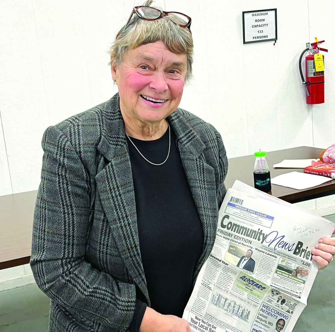 Cheryl Douglas with one of her articles about St. Francis Hospital in the Community News Brief newspaper